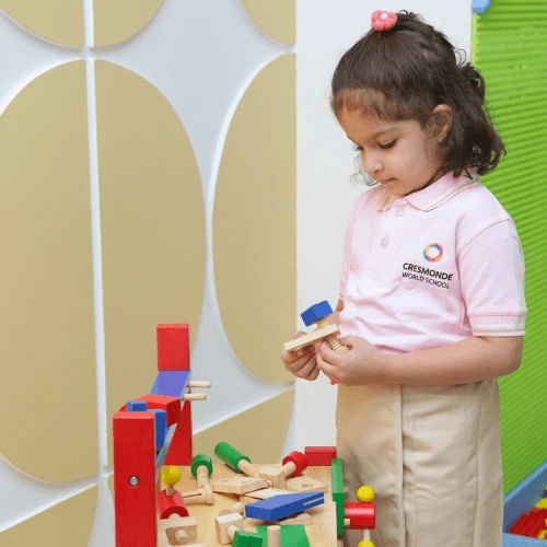 Young student playing with educational wooden toys at Cresmonde, international school in Andheri