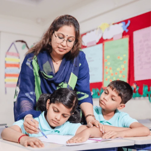 Teacher guiding students in classroom at Cresmonde, International school in Andheri
